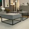 A modern living room setting with two coffee tables, decorative items, and artwork. Produktbild-Vorschau
