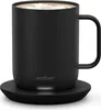 A black Ember mug filled with coffee, sitting on its charging coaster. Náhled obrázku produktu