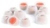 A collection of white silicone earbud tips with orange inner cores, arranged on a white background. Produktbild-Vorschau