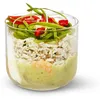 A glass container filled with layers of food, including rice, a green sauce, and toppings. Podgląd zdjęcia produktu