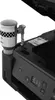 A close-up view of a Canon PIXMA G2470 printer with an ink bottle attached. Produktbild-Vorschau