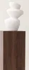 A white textured sculpture made of stacked, rounded shapes sits on a dark brown wooden pedestal. Produktbild-Vorschau