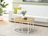 A living room scene with a white couch, coffee table set, and a plant. Náhľad obrázku produktu