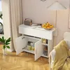 A white cabinet with open doors revealing shelves filled with boxes and jars. A bowl of fruit sits on top, next to a radio and books. Voir les images du produit