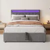 A grey upholstered bed with purple LED lighting on the headboard, set up in a bedroom. Náhľad obrázku produktu