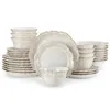 A collection of white and beige ceramic tableware, including plates and bowls, arranged on a white background. Produktbild-Vorschau