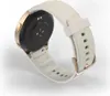 The back of a smartwatch with a white strap and gold accents is shown against a white background. Voir les images du produit