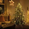 A decorated Christmas tree with lights and ornaments, set in a cozy room with a bench and pillows. Produktbild-Vorschau