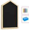 A house-shaped chalkboard with a wooden frame, shown with chalk and a sponge. Produktbild-Vorschau