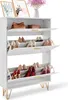 A white shoe cabinet with multiple shelves and flip-down doors, displaying various shoes and accessories. Produktbild-Vorschau