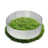 A circular metal border containing lush green grass, set against a white background. Produktbild-Vorschau