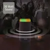 A portable speaker with colored lights is shown in a dark, atmospheric setting with blurred people dancing in the background. Voir les images du produit