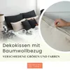 A person is sitting on a bed with several decorative pillows. A close-up of a pillowcase with a zipper is shown in a circular inset. Produktbild-Vorschau