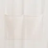 A close-up view of two pockets on a cream-colored fabric. Voir les images du produit