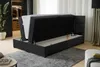 A black boxspring bed with the storage compartment open, revealing the mattress inside. The bed is in a modern bedroom setting with a closet visible in the background. Produktbild-Vorschau