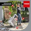 A woman is shown pulling a garden shredder on wheels. Produktbild-Vorschau