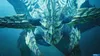 A close-up, underwater view of a large, dragon-like creature with sharp, rocky scales and glowing green eyes. Anteprima dell’immagine prodotto