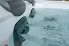 A close-up view of a hot tub with water jets active. Produktbild-Vorschau