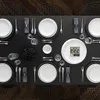 A formal table setting with plates, cutlery, and napkins arranged on a black tablecloth. Voir les images du produit