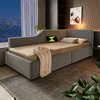 A modern bedroom with a gray sofa bed, city view through the window, and plants. Produktbild-Vorschau