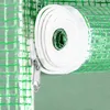 Close-up of a rolled-up white strap next to a green mesh material, with a zipper visible. Produktbild-Vorschau