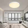 A modern living room with a ceiling light, sofa, coffee table, chair, and window. Produktbild-Vorschau