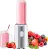 A portable blender with a smoothie in the bottle, a glass of smoothie, and a pile of fresh berries. Produktbild-Vorschau