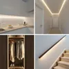 A collage of four images showing LED strip lights installed in different home settings: a kitchen, a hallway, a closet, and a staircase. Náhled obrázku produktu