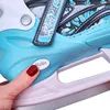 A close-up shot of a person's finger pressing a "PUSH" button on a blue ice skate. Podgląd zdjęcia produktu