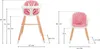 A size chart showing two pink high chairs with wooden legs, with dimensions indicated by lines and numbers. Produktbild-Vorschau