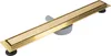 A linear shower drain with a gold finish and a gray drain pipe. Náhled obrázku produktu