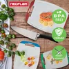A collection of Neoflam cutting boards with food items and a knife, presented on a wooden surface. Produktbild-Vorschau