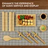 A flat lay of a sushi making set and sushi on a checkered cloth. Produktbild-Vorschau