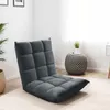 A gray floor chair is shown in a room with a plant and a side table. Náhled obrázku produktu