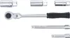 A set of tools, including a ratchet and various socket attachments, laid out on a white background. Anteprima dell’immagine prodotto