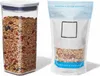 A clear studio shot of a food storage container filled with granola and a resealable bag of granola, both on a white background. Náhled obrázku produktu