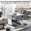 A person is pouring coffee beans into an espresso machine on a kitchen counter. Produktbild-Vorschau