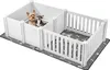 Two white dog crates are shown side-by-side on a gray mat with a bone and paw print pattern. Two small dogs are in the left crate, and one small dog is in the right crate. Podgląd zdjęcia produktu