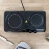 A black double electric hot plate on a wooden surface. Náhľad obrázku produktu