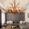 A living room with a sectional sofa, coffee table, and a antler chandelier. Podgląd zdjęcia produktu