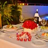 A romantic dinner setting with food, wine, roses, and candles. Produktbild-Vorschau