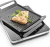 A close-up shot of a HENDI induction cooker with a grill pan on top, cooking a piece of salmon. Anteprima dell’immagine prodotto