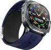 A close-up, angled view of a blue smartwatch with a gray bezel and a black inner strap, set against a white background. Náhled obrázku produktu