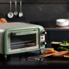 A vintage-style countertop oven is shown in a kitchen setting, with food items like salmon and dips in the foreground. Anteprima dell’immagine prodotto