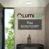 A modern bathroom with a black bathtub and a LUMILED LED ceiling lamp. Podgląd zdjęcia produktu