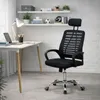 A black office chair is positioned next to a white desk in a room with white brick walls and shelves. Produktbild-Vorschau