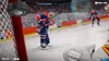 A hockey player in an Edmonton Oilers uniform is about to shoot a puck towards a net, with a goalie's glove visible in the foreground. Produktbild-Vorschau