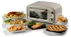 A retro-style toaster oven is displayed alongside a variety of prepared foods, including roasted chicken, a rolled roast, mini pizzas, salmon, bread rolls, and a pie. Náhled obrázku produktu