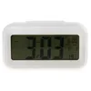 A white digital alarm clock with a large LCD screen displaying the time, date, temperature, and alarm settings. Náhled obrázku produktu