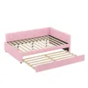 A pink upholstered daybed with a pull-out trundle bed extended. Podgląd zdjęcia produktu